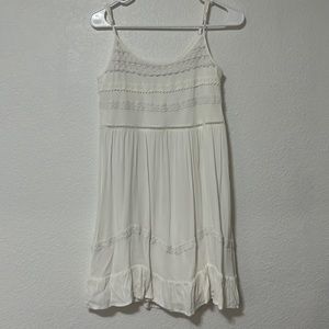 white flows dress with lace design on chest